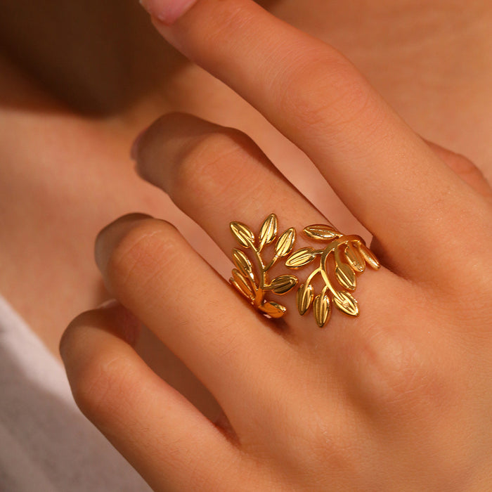 Close-up of hand wearing Noora olive leaf ring in gold