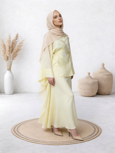 Woman in lime abaya with gentle flow and comfortable fit