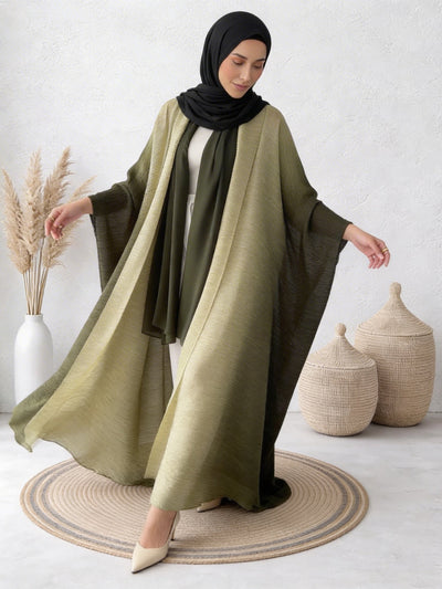 Woman wearing Sultana seaweed abaya with flowing layers and natural movement