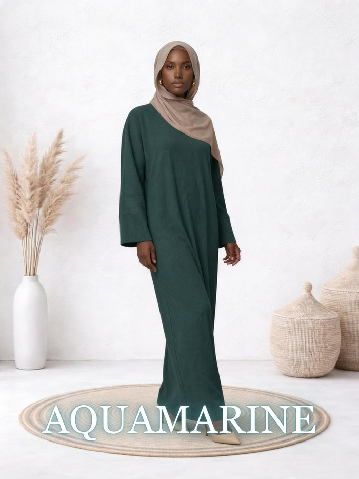 Model wearing the Amanah Abaya in Aquamarine, featuring a rich teal tone and relaxed drape.