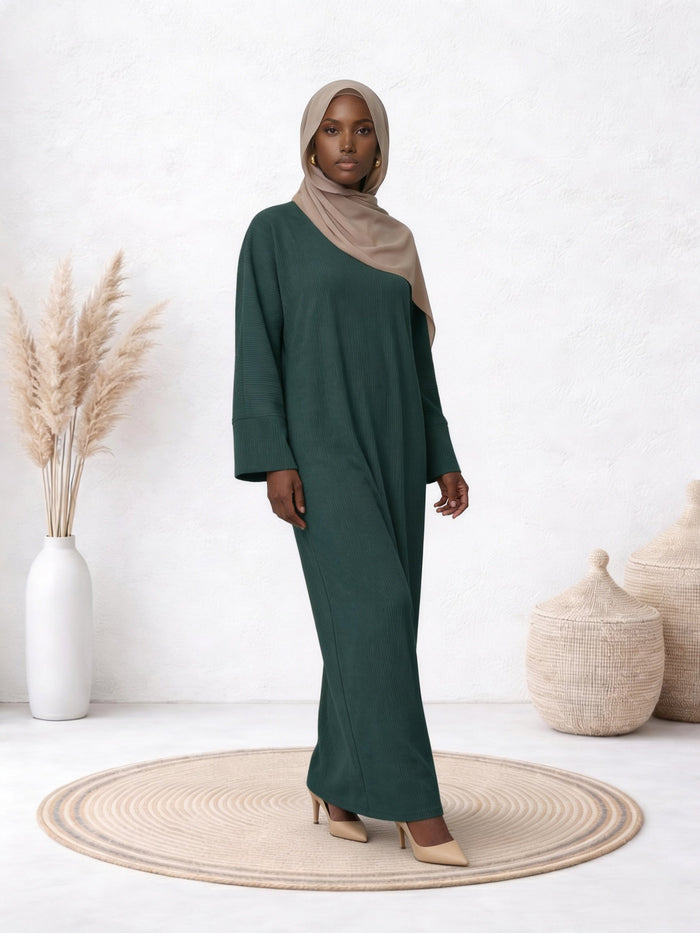Full-length view of a model wearing the Amanah Abaya in Aquamarine, showcasing its elegant teal shade and flowing silhouette.