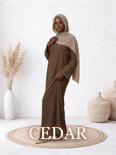 The Amanah Abaya in Cedar shown on a model, highlighting its warm brown shade and modest silhouette.