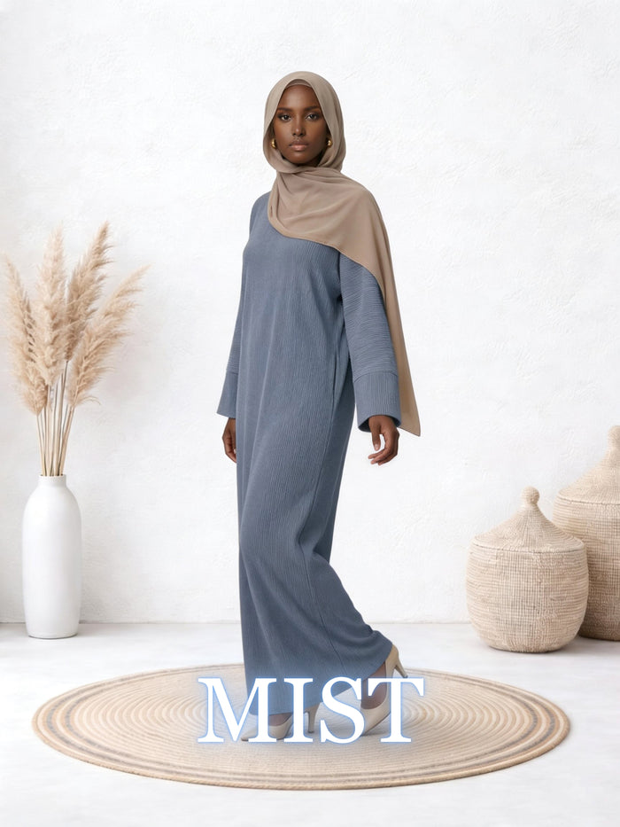 Model showcasing the Amanah Abaya in Mist, featuring a soft blue-grey shade and comfortable full-length fit.