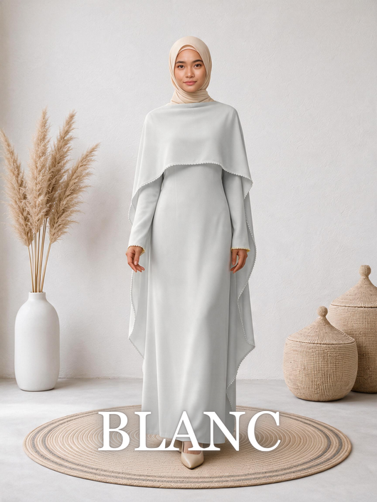 Front-facing woman wearing the Amara™ Abaya in Blanc, showcasing the clean silhouette and flowing cape.