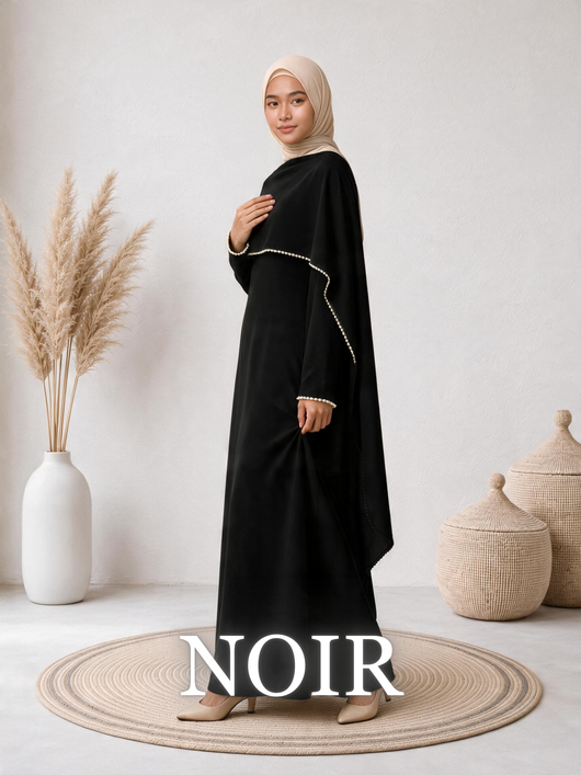 Side-view of a woman wearing the Amara™ Abaya in Noir, highlighting the elegant cape detail.