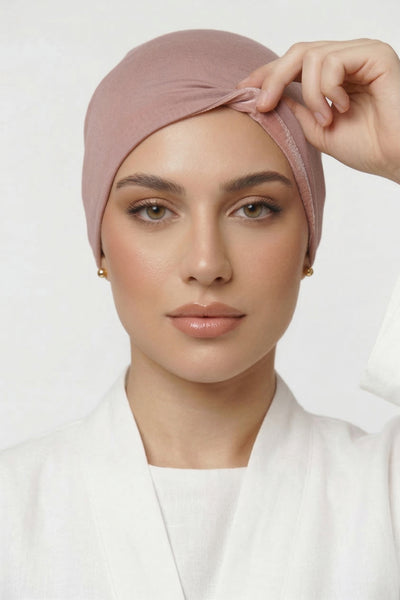 Model lifting praline Blush Amina velvet hold undercap to reveal velvet grip front panel in white studio