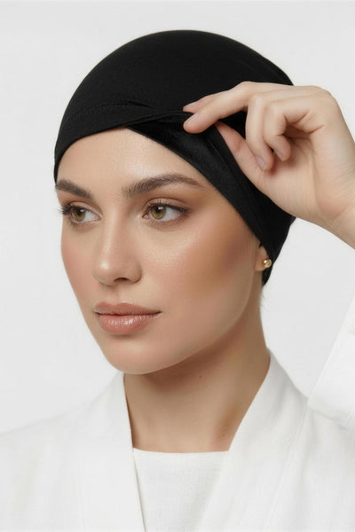 Model lifting black Amina velvet hold undercap to reveal velvet grip front panel in white studio