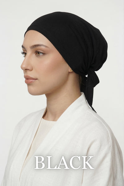 Model lifting black Amina velvet hold undercap to reveal velvet grip front panel in white studio