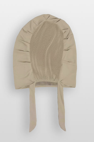 Flat lay of praline beige Amina velvet hold undercap with mesh back and adjustable tie-back in white studio