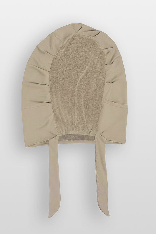 Flat lay of praline beige Amina velvet hold undercap with mesh back and adjustable tie-back in white studio