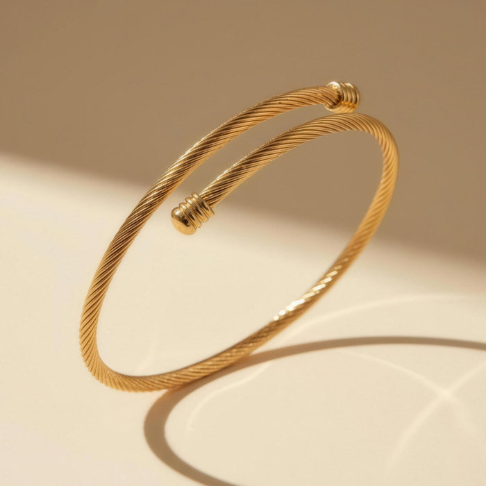 Zayra twisted cable bracelet in gold on minimal background with soft lighting