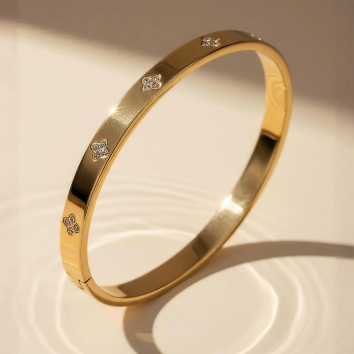 Yasmin bangle in clover gold with polished finish in soft studio lighting