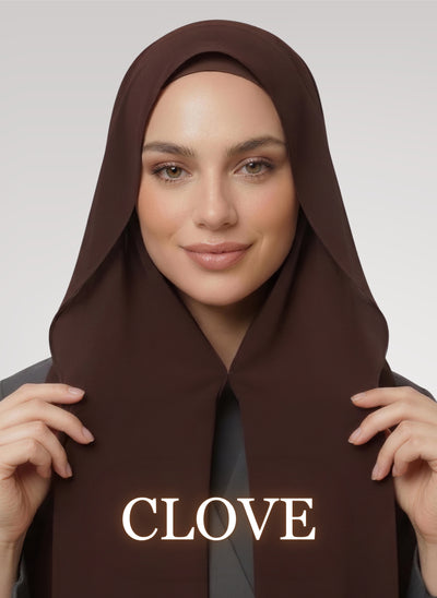 Woman wearing Clove brown NurAmira instant chiffon hijab with front panels held by magnets and smooth drape in white studio