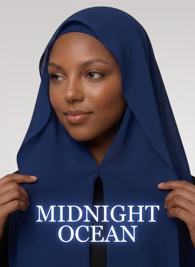 Woman wearing midnight ocean blue NurAmira instant chiffon hijab with front panels held by magnets and smooth drape in white studio