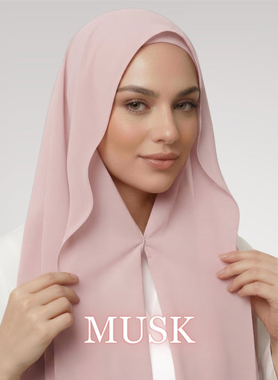 Woman wearing musk pink NurAmira instant chiffon hijab with front panels held by magnets and smooth drape in white studio