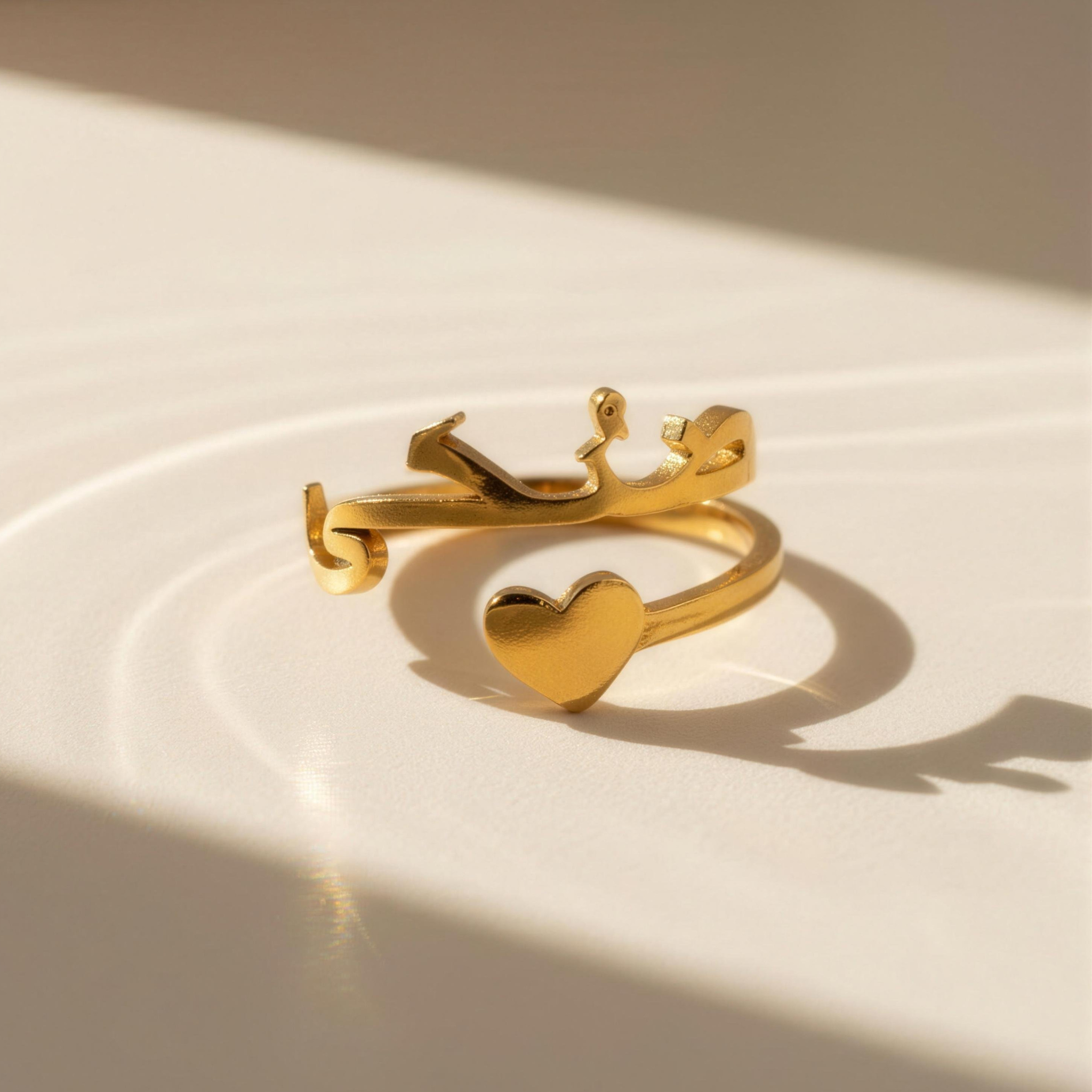 Close-up of Maktub gold ring with heart detail in soft sunlight