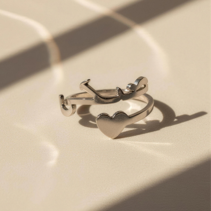 Close-up of Maktub silver ring with heart detail in soft lighting