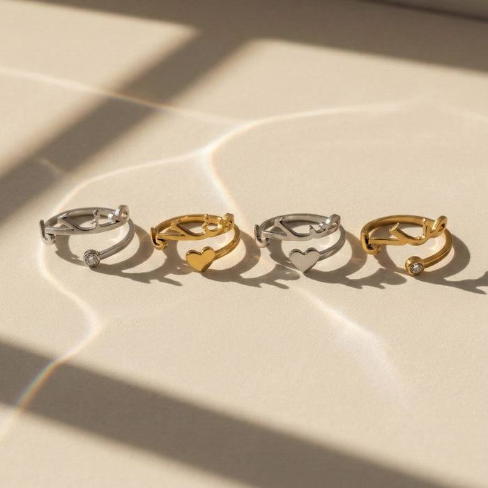 Set of Maktub rings in gold and silver with heart and stone details