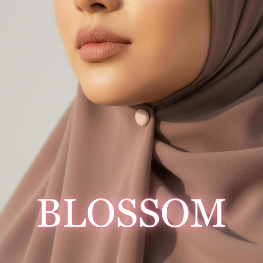 Close-up of a model wearing a brown hijab secured under the chin with a matte dusty pink "Blossom" magnet, with the text "BLOSSOM" overlaid at the bottom.