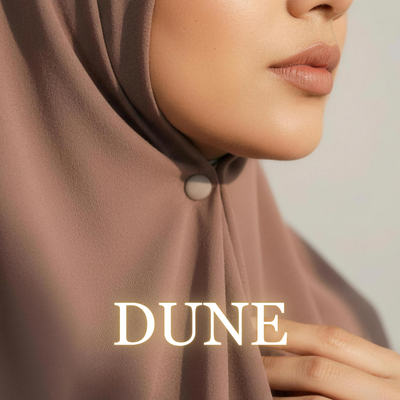 Close-up of a model wearing a dusty rose hijab secured under the chin with a matte nude beige "Dune" magnet, with the text "DUNE" overlaid at the bottom.