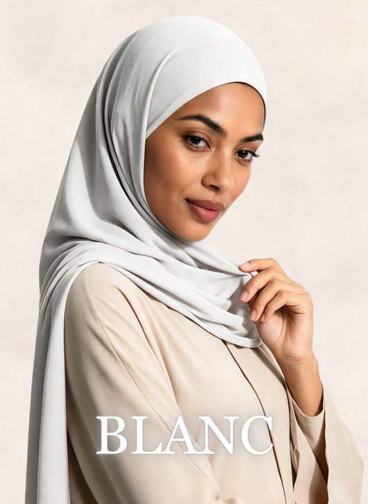 Woman wearing Nasma Instant Airy Jersey Hijab in Blanc white shade, side profile view.