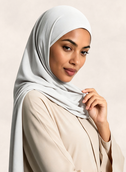 Woman wearing Nasma Instant Airy Jersey Hijab in Blanc white shade, side profile view.