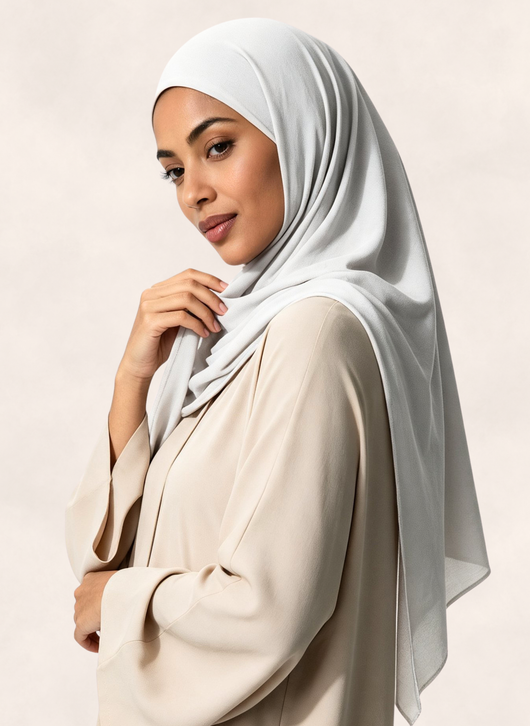 Woman wearing Nasma Instant Airy Jersey Hijab in Blanc white shade, right side angle view.