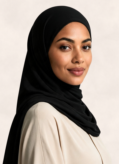 Woman wearing Nasma Instant Airy Jersey Hijab in Noir black shade, right side angle view