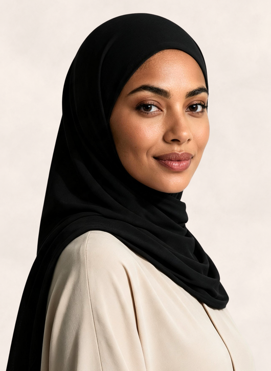 Woman wearing Nasma Instant Airy Jersey Hijab in Noir black shade, right side angle view