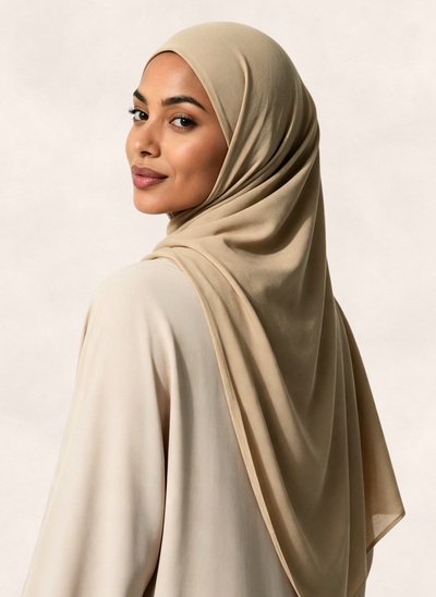 Woman wearing Nasma Instant Airy Jersey Hijab in Oat beige shade, right side angle view