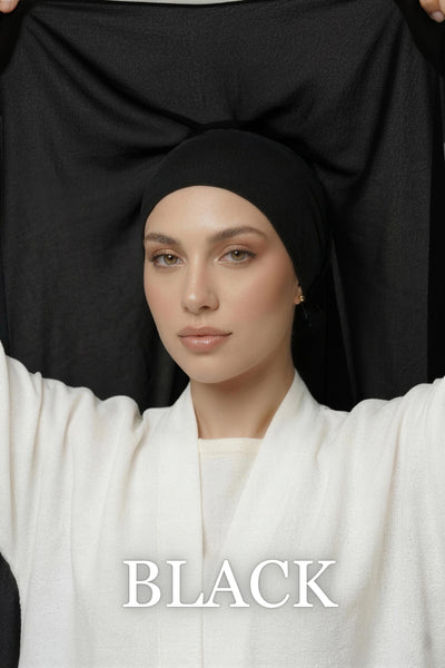 Woman wearing new Nuramira black instant chiffon hijab with upgraded adjustable mesh undercap with grip