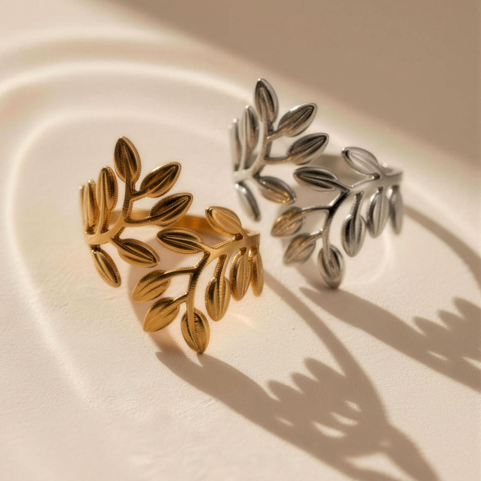 Noora olive leaf ring in gold and silver on minimal background