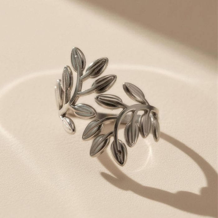 Noora olive leaf ring in silver on soft textured surface