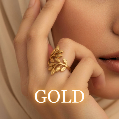 Woman wearing Noora olive leaf ring in gold with soft lighting