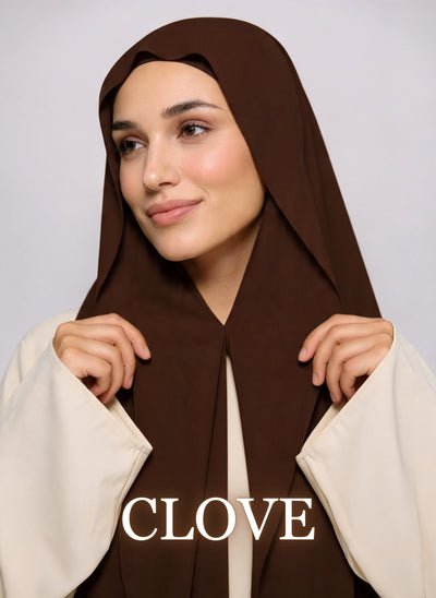 Woman wearing Clove brown NurAmira instant chiffon hijab with front panels held by magnets and smooth drape in white studio