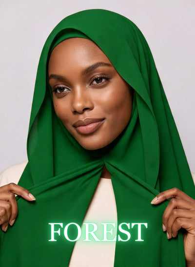 Woman wearing forest green NurAmira instant chiffon hijab with front panels held by magnets and smooth drape in white studio