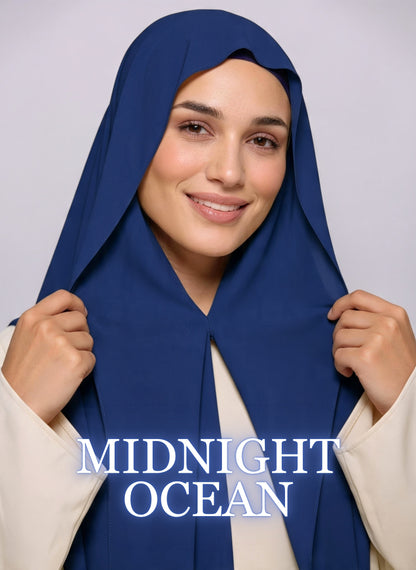 Woman wearing midnight ocean blue NurAmira instant chiffon hijab with front panels held by magnets and smooth drape in white studio