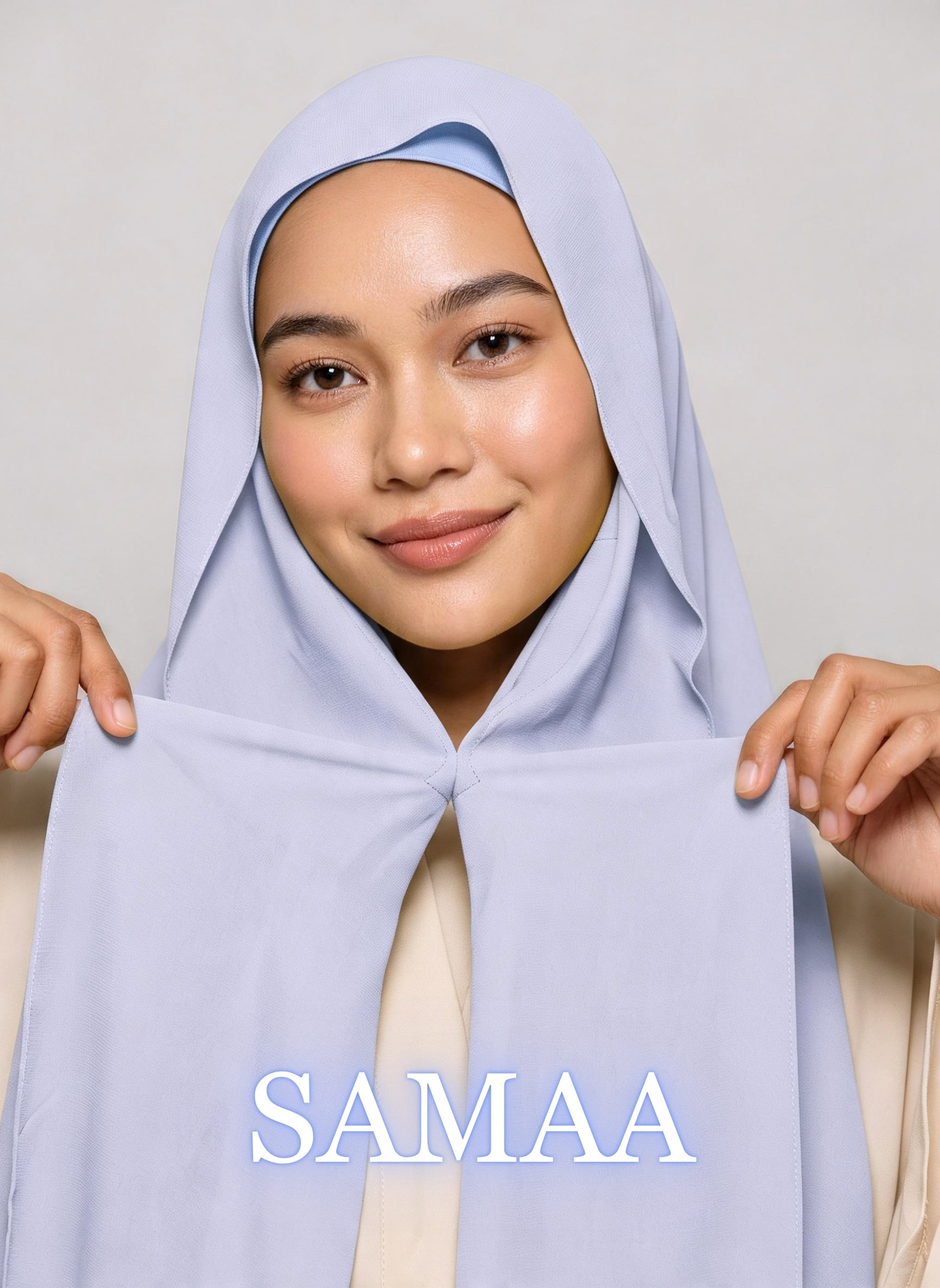 Woman wearing icy blue samaa NurAmira instant chiffon hijab with front panels held by magnets and smooth drape in white studio