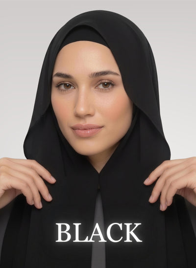 woman wearing black scarf with flowy style, both hand holding the fabric up.