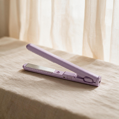 NurAmira Hijab Straightener in Lily lavender shade, closed on fabric surface.