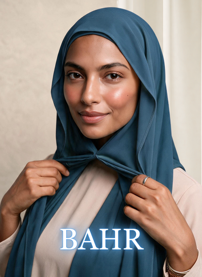 Woman wearing NurAmira Instant Chiffon Hijab in Bahr deep teal-blue shade, draped and knotted style.