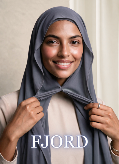 Woman wearing NurAmira Instant Chiffon Hijab in Fjord slate-gray shade, draped and knotted style.