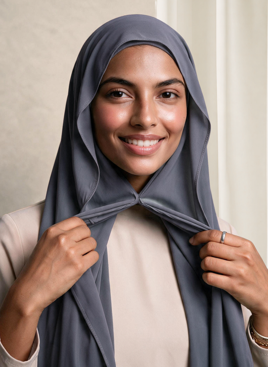 Woman wearing NurAmira Instant Chiffon Hijab in Fjord slate-gray shade, smiling, draped and knotted style.
