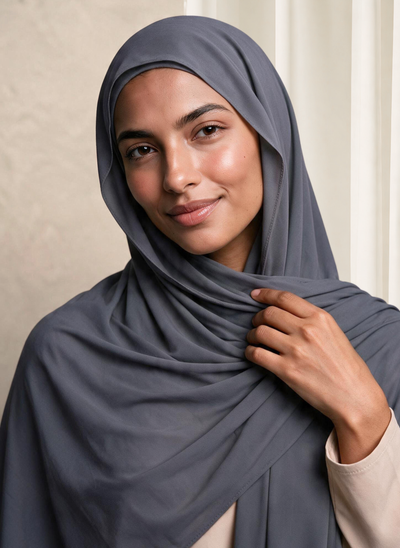 Woman wearing NurAmira Instant Chiffon Hijab in Fjord slate-gray shade, draped and knotted style.