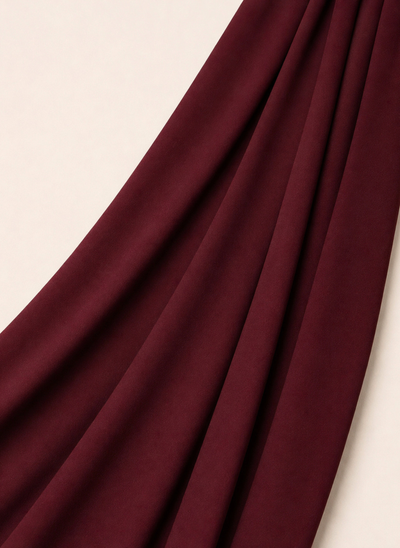 Close-up of NurAmira Instant Chiffon Hijab fabric texture in Garnet deep red shade, soft draped folds.