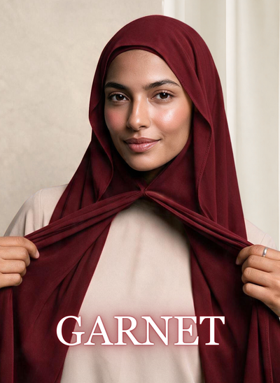 Woman wearing NurAmira Instant Chiffon Hijab in Garnet deep red shade, draped and knotted style.