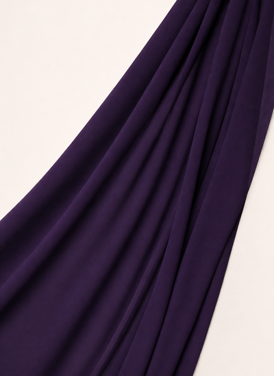 Close-up of NurAmira Instant Chiffon Hijab fabric texture in Iris deep purple shade, soft draped folds.