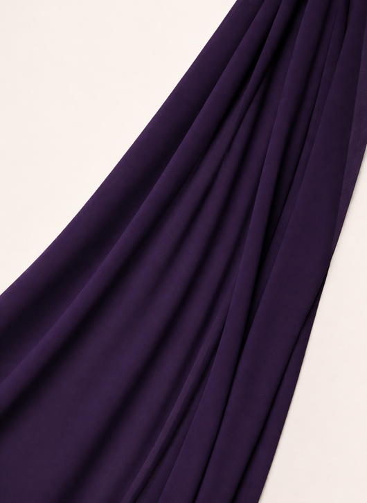 Close-up of NurAmira Instant Chiffon Hijab fabric texture in Iris deep purple shade, soft draped folds.