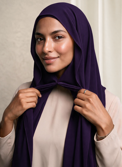 Woman wearing NurAmira Instant Chiffon Hijab in Iris deep purple shade, magnet closure style.