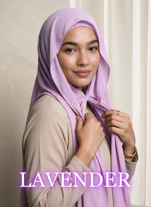 Woman wearing NurAmira™ Instant Chiffon Hijab in Lavender, holding the front of the hijab.